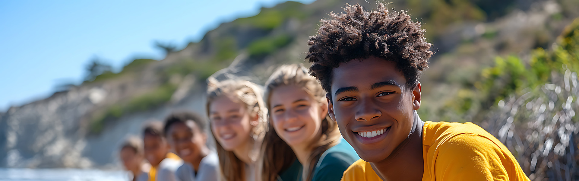 Smiling group of diverse teens outdoors promoting substance use prevention